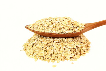  rolled oats flakes for breakfast in spoon on heap in white background
