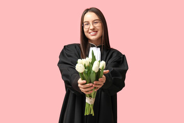 Young female judge with white tulips on pink background. Women's Day celebration