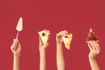 Many hands holding pizza slices and spatula on red background
