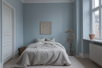 Minimalist bedroom in Stockholm with streamlined furniture, cool blue tones, and morning light, inviting tranquility and space.
