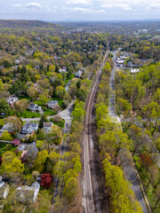 This drone-captured image offers a stunning overview of a prosperous neighborhood in Millburn, NJ,...
