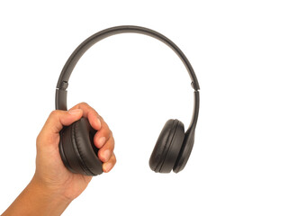Hand holding black wireless headphones.