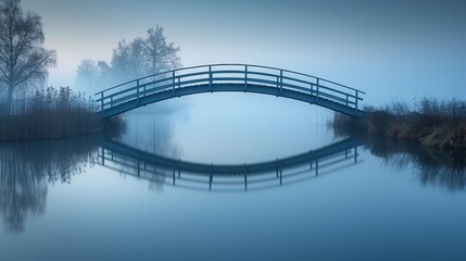 Misty morning view of a simple blue footbridge reflecting over tranquil waters, Concept of calmness and crossing over in serene landscapes