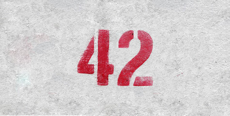 Red Number 42 on the white wall. Spray paint.