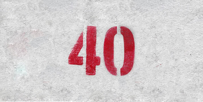 Red Number 40 on the white wall. Spray paint.