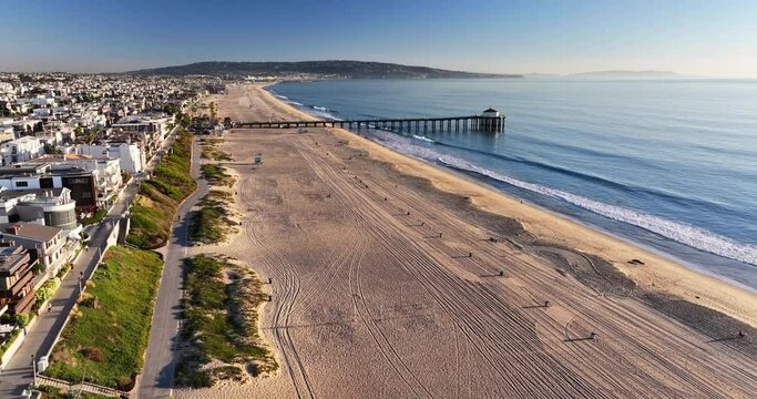 A Serene Aerial Perspective Of A Wide Sandy Beach Leading To A Classic Pier, With The Quiet Morning Light Casting Gentle Shadows. - Manhattan Beach, California
