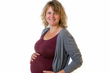 Smiling and cradling her pregnant belly, a woman stands confidently, symbolizing the anticipation and joy of impending motherhood