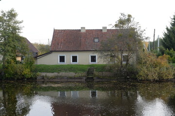 Fototapeta na wymiar House on the bank of the Polessky Canal in the Kaliningrad region
