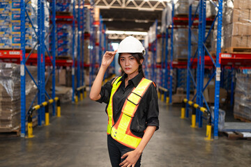 Portrait of female supervisor standing in warehouse with looking at camera, Logistic industry concept.