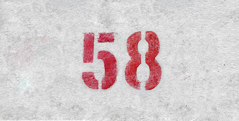Red Number 58 on the white wall. Spray paint.