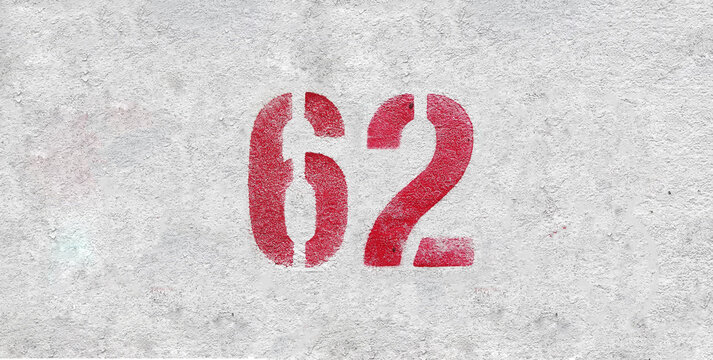 Red Number 62 on the white wall. Spray paint.