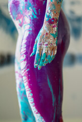 hand, stomach, bottom, hips, thighs of sexy young nude woman, in turquoise, pink, violet and white color painted decorative. Creative expressive abstract body painting art