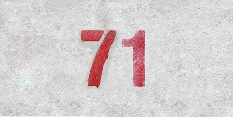 Red Number 71 on the white wall. Spray paint.