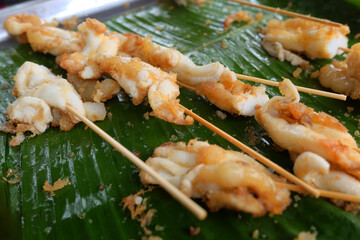 Squid eggs grilled on banana leaf. Seafood on street food in Thailand