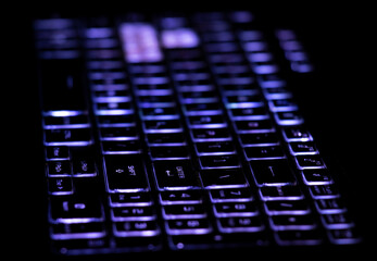  Keyboard with blue backlight and enter button close-up