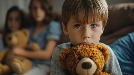 A child clutching a teddy bear, with audible arguing in the background