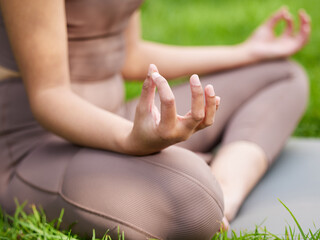 Woman, hands and meditation with yoga in garden for mindfulness, holistic zen and balance on lawn....