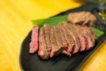 Sliced medium rare grilled beef ribeye steak. Close up