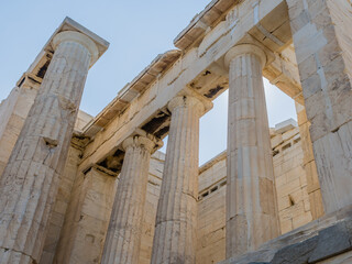 Close-up of weathered Ionic columns of a Greek temple ruin, in Athens Greece