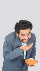 portrait view of a man, tasty and delicious corn cob seeds in hand to eating gesture with facial expression.