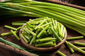 fresh garlic bolt on wooden table.