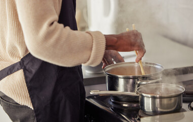 Hands, cooking and pot with steam in the home for lunch or dinner, busy and hungry for food with...