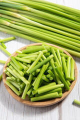 fresh garlic bolt on wooden table.