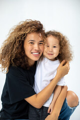 Happy loving family. Mother and her daughter child girl playing and hugging.