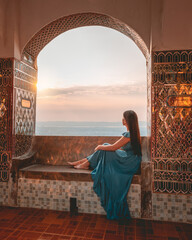 Couple sitting and admiring the view from above at Mandalay Hill, Myanmar during sunset.