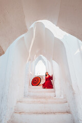 Young woman visits the white Hsinbyume Pagoda during sunset. in Myanmar.