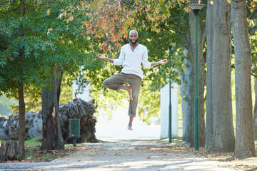 Man, levitate and meditation with yoga outdoor, portrait or exercise in park with health and...