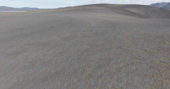 Aerial: Drone Forward Tilt Up Scenic View Of Volcanic Rocks Under Sky - Unknown, Iceland