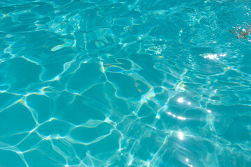 Fototapeta na wymiar Background of azure blue water in the bright sun