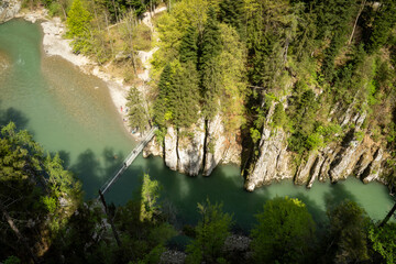 Entenlochklamm with suspension bridge over the impressive gorge of the Tiroler Achen. Hike along...