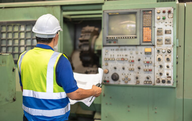 Senior Engineer Analyzes Blueprint for Machine Maintenance in Industrial Factory Setting