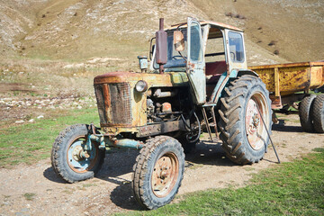 An old vintage tractor on a farm. Non-working condition, rust. - 790593839