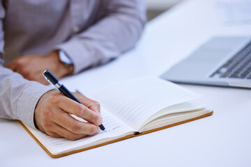 Hands, writing notes and person in office with ideas, reminder and lead for story at media company....