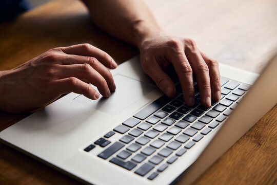 Detail picture of man using laptop touchpad