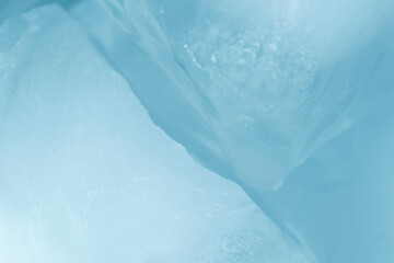 Chrystal clear frosty textured natural ice block in cold light blue tones