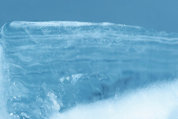 Chrystal clear frosty textured natural ice block in cold light blue tones