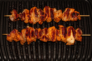 Closeup of meat prepared on electric grill - obrazy, fototapety, plakaty