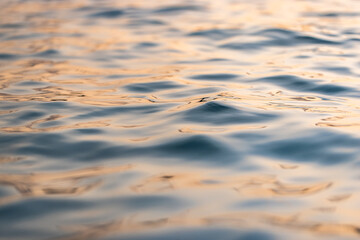 Beautiful sea waves ripples and sky reflection at sunset sunlight. Dream nature, beauty in nature ocean ecology concept. Artistic golden pastel blue fluid background. Closeup abstract natural light - 790610234