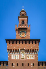 Fototapeta na wymiar Exterior view clock tower of the Sforza Castle. It was built in the 15th century. Close-up with details. View, details, architectures and embellishments.
