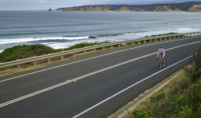 Cyclist  travels the scenic Great Ocean Road in south Western Victoria