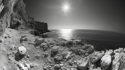 Dramatic black and white fisheye view of a rocky shore under a radiant sun