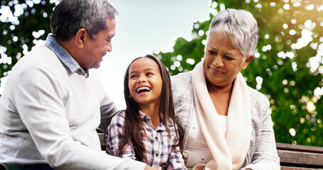 Park, bench and happy grandparents with child, smile and bonding on outdoor adventure together. Old...