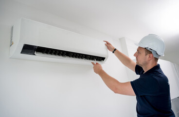 technician cleans air conditioner system in a modern apartment.