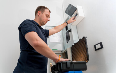A technician works with a demo kit of the smart home system