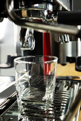 Coffee machine with empty glass cup. Making Italian expresso coffee.
