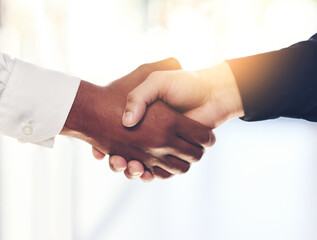 Business people, handshake and meeting with partnership for agreement, b2b or deal together at office. Closeup of employees or colleagues shaking hands for teamwork, unity or thank you at workplace